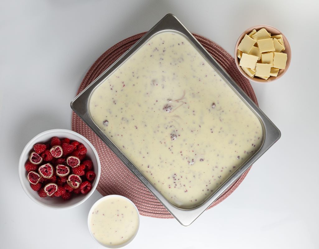 Cuba de sorvete coberta com recheio de chocolate branco e framboesa.